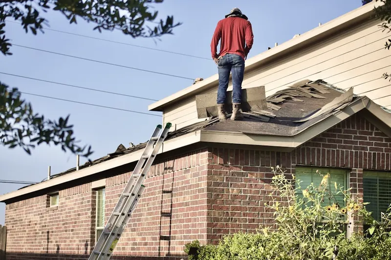 Professional roofer working on a residential roof in Edgelawn Randall